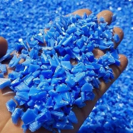 Blue HDPE plastic regrind granules in hand
